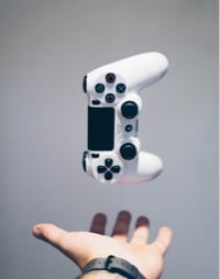 gaming controller floating above spread out hand